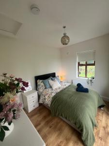 a bedroom with a bed and a table and a window at The Cuckoos Nest - 2 bedroom in Headford
