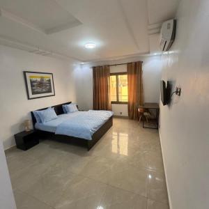 a bedroom with a bed with blue pillows on it at World Prestige Properties in Dakar