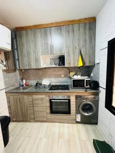 a kitchen with a stove and a microwave at World Prestige Properties in Dakar