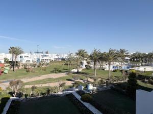 a view of a park with palm trees and a playground at Townhouse in Ras Elhekma
