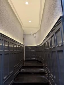 a locker room with black doors and a hallway at Hotel Savaya Luxury Stay Near AIIMS Rishikesh in Rishīkesh +24 photos