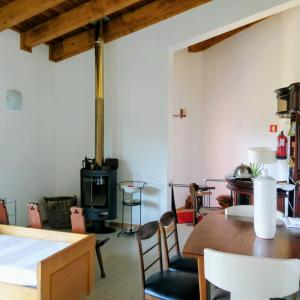a living room with a table and a wood stove at Douro Balcony in Resende