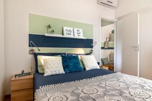 a bedroom with a bed with a blue headboard at Mint House in Vasto