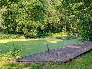 a wooden boardwalk in a pond in a park at The Wherry Arch in Neatishead