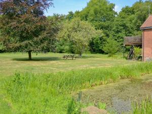a park with a picnic table and a tree at The Wherry Arch in Neatishead +9 photos