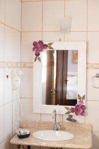 a bathroom with a sink and a mirror at Casa de Violeta Pousada in Tiradentes +219 photos