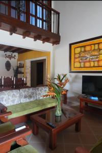 a living room with a couch and a table at La Mona in Calima