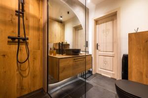 a bathroom with a shower with a sink and a glass door at Rogata Chata Tatra View & Jacuzzi in Kościelisko +95 photos