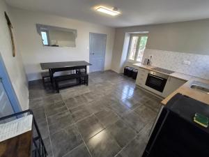 a kitchen with a sink and a table in it at 16 Chemin De Compostelle in Sénergues