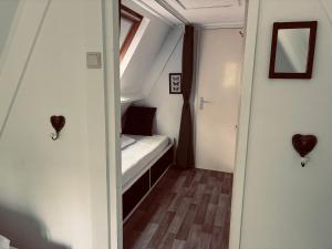 a small room with a bed and a window at Chalet AchiLou in Durbuy +39 photos