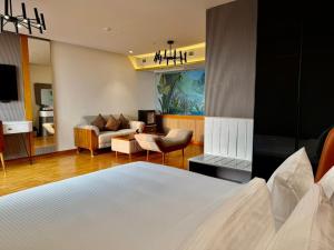 a bedroom with a bed and a living room at SKI - Sivakavi Iconic in Pondicherry +124 photos