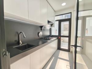 a kitchen with a sink and a window at Mallow Semi-D homestay in Rawang