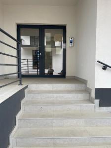 a person sitting in front of a building at RelaxDream in Sînmartin