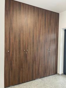 a large wooden cabinet with two doors in a room at RelaxDream in Sînmartin