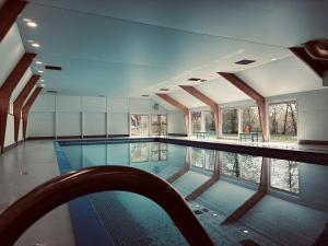 a swimming pool with a view of the water at Chalet AchiLou in Durbuy