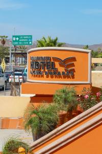a sign for a hotel malayan durandal dogs at Hotel Boutique Plaza Doradas in San José del Cabo
