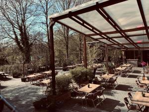 a patio with tables and chairs and a pavilion at Chalet AchiLou in Durbuy