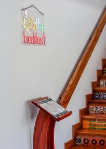 a sign for a coffee house next to a staircase at Hotel Boutique Plaza Doradas in San José del Cabo