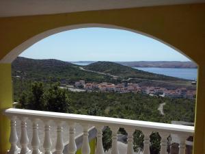 a balcony with a view of a town and water at Apartment Stinica 26 E in Jablanac