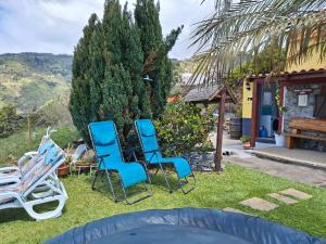 a group of chairs in the yard of a house at Casa d'Alegria Madeira Island in Ribeira Brava