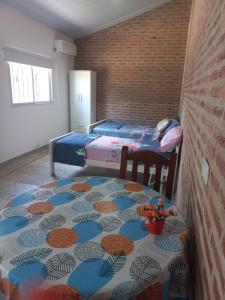 a bedroom with two beds and a table with a patterned floor at La Leonor in Formosa