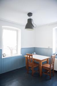 a dining room with a table and two chairs at Pim's in Steffeln +9 photos