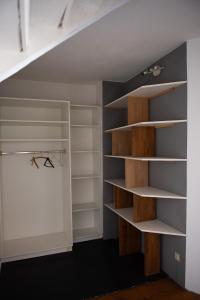 a closet under the stairs with white shelves at Pim's in Steffeln
