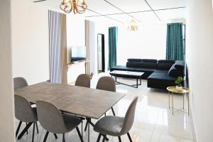 a living room with a table and chairs and a couch at Lagrande CBD in Benoni