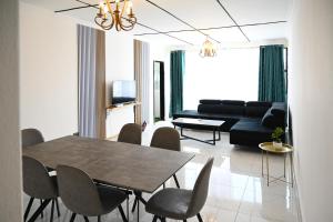 a living room with a table and chairs and a couch at Lagrande CBD in Benoni