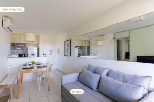 a living room with a couch and a table at Equipped studio with sea view VG Sun Cumbuco in Paracumbuca