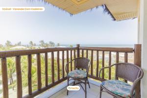 two chairs sitting on a balcony looking out at the ocean at Equipped studio with sea view VG Sun Cumbuco in Paracumbuca
