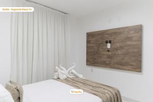two stuffed animals sitting on a bed in a bedroom at Equipped studio with sea view VG Sun Cumbuco in Paracumbuca