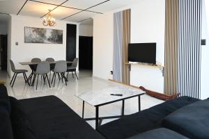 a living room with a couch and a table at Lagrande CBD in Benoni +12 photos