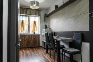 a dining room with a table and chairs at Apartament Deea in Orşova +27 photos