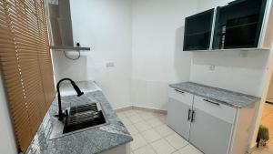 a kitchen with a sink and a counter top at Journy B Holiday Inn Ekala in Ekala