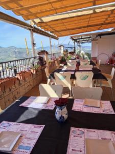 a row of tables and chairs on top of a building at "Rincón de Marcelo" Pension in Tózar +160 photos