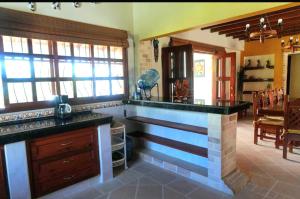 a kitchen with a counter and a dining room at La Mona in Calima