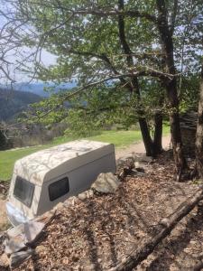 a camper sitting in the shade of a tree at Caravane dans les Cévennes in Saint-Germain-de-Calberte +11 photos