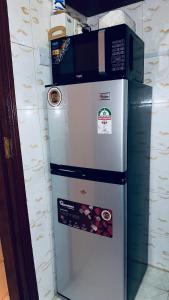 a refrigerator with several stickers on the top of it at ZulynHomes in Kisumu