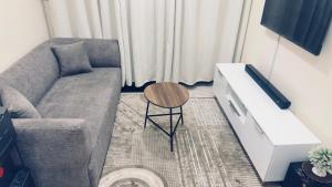 a living room with a couch and a table at ZulynHomes in Kisumu +2 photos