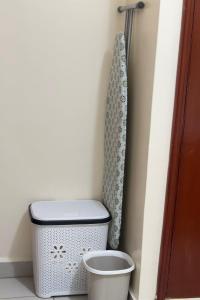 a bathroom with a toilet and a shower curtain at ZulynHomes in Kisumu