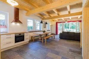 a large kitchen with a table and a couch at Welsh House in Siedlung Schönwalde
