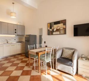 a kitchen and dining room with a table and chairs at Mermaid Hotel Vlore in Vlorë