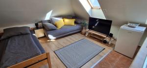 a living room with a couch and a flat screen tv at Takács Vendégház 2 in Sopron