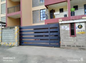 a blue gate in front of a building at Nolan's Comforts Kitengela in Kitengela 