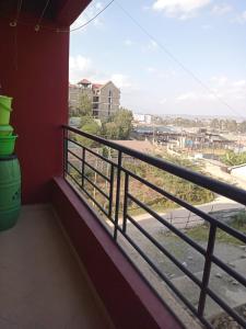 a balcony with a view of a city at Nolan's Comforts Kitengela in Kitengela  +2 photos