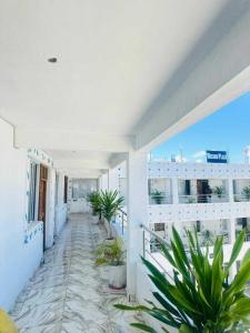 a balcony with potted plants on a building at Reign homes in Watamu