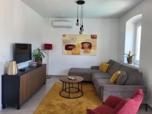 a living room with a couch and a table at Casa Solis Losinj in Mali Lošinj