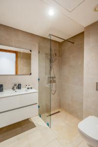 a bathroom with a shower and a sink and a toilet at Noria Golf Apartment in Marrakesh +26 photos