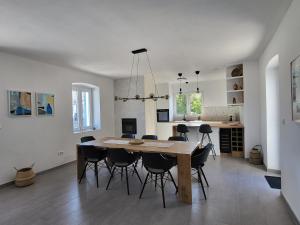 a dining room and kitchen with a table and chairs at Casa Solis Losinj in Mali Lošinj